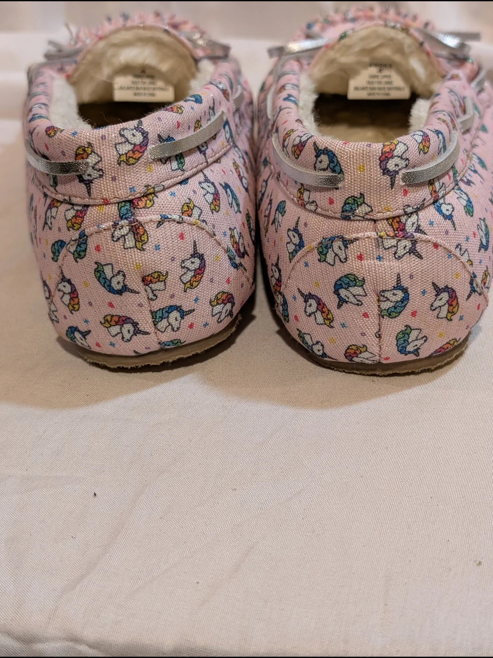 Minnetonka Pink Unicorn Print Moccasin Slippers with Silver Bow Accent